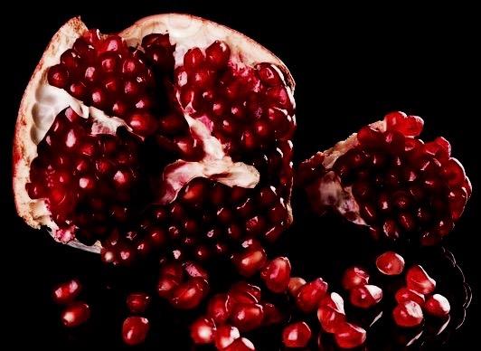 1782174-fresh-ripe-pomegranate-and-glass-of-red-wine-on-black-background (1).jpg